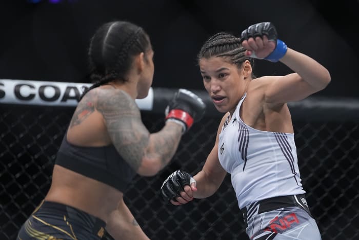 Julianna Pena defends against Amanda Nunes during UFC 269 at T-Mobile Arena.